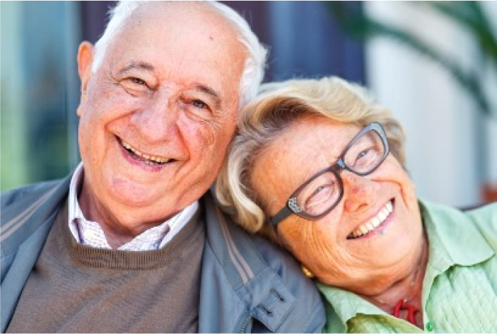 Elderly couple enjoying each other&#039;s company with smiles and laughter.