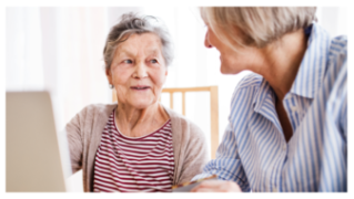 A senior woman and her caregiver, providing support and companionship.